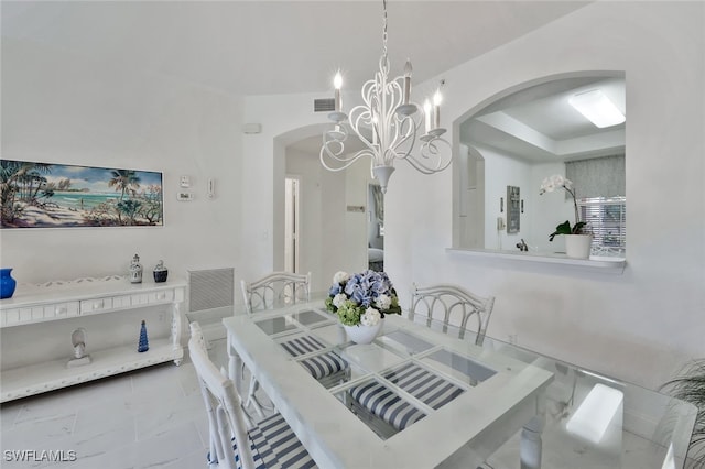 dining space featuring an inviting chandelier