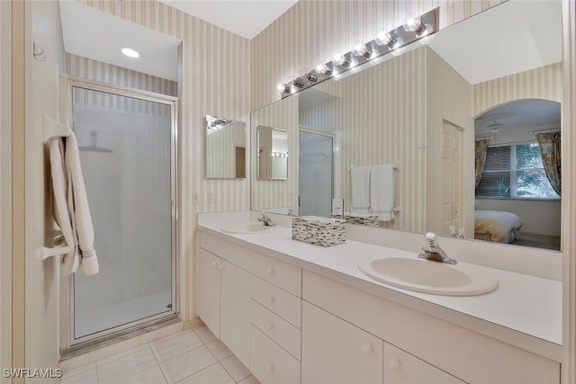 bathroom with tile patterned flooring, vanity, and a shower with door