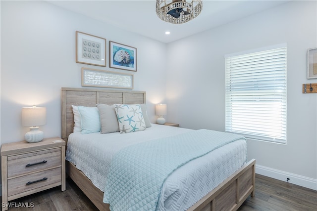 bedroom with dark hardwood / wood-style flooring