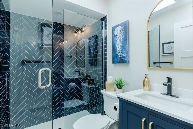 bathroom featuring vanity, toilet, and an enclosed shower