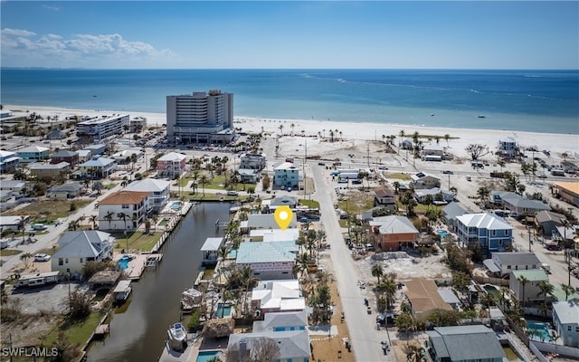 bird's eye view with a water view and a beach view