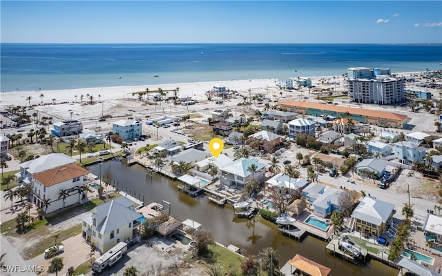 drone / aerial view featuring a water view and a beach view