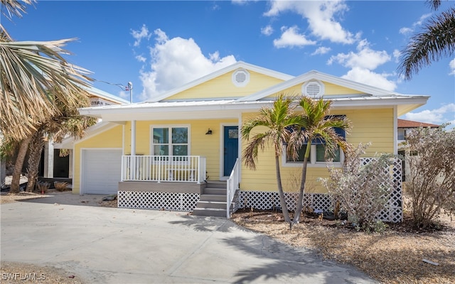 view of front of home with covered porch and a garage