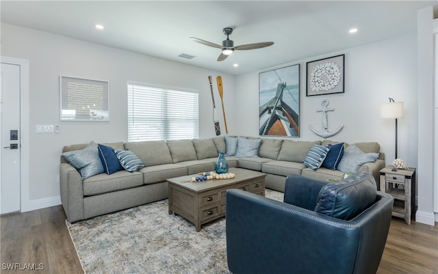 living room featuring ceiling fan and hardwood / wood-style flooring