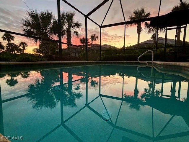 pool at dusk with a lanai