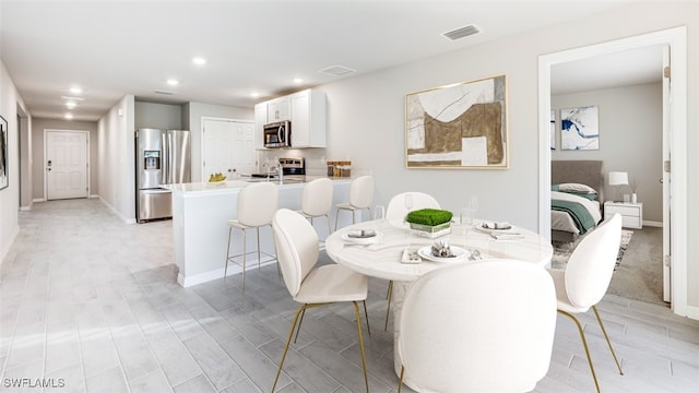 dining space with light hardwood / wood-style flooring