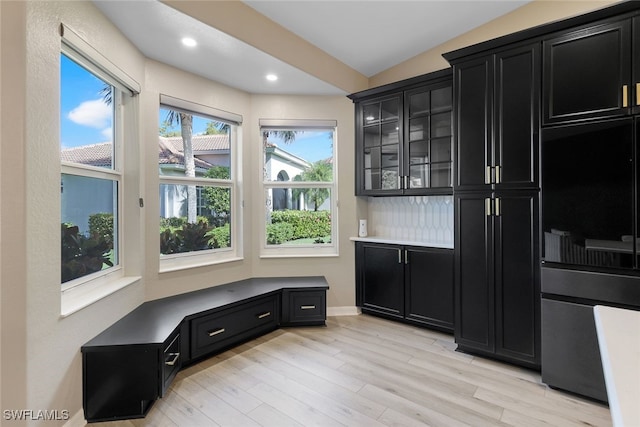 mudroom with light hardwood / wood-style floors and lofted ceiling