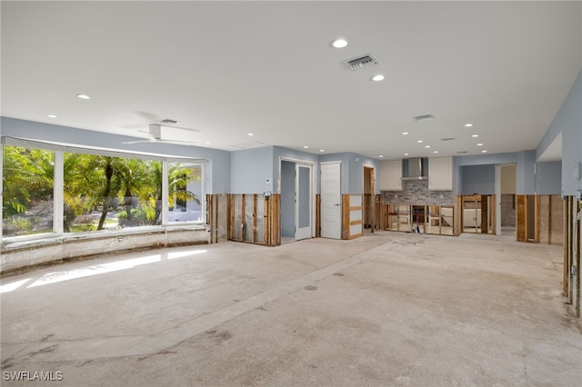 unfurnished living room featuring ceiling fan