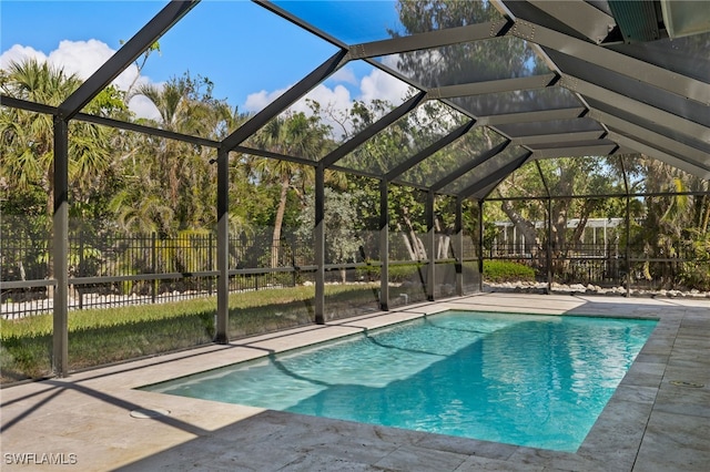 view of swimming pool with a patio and a lanai