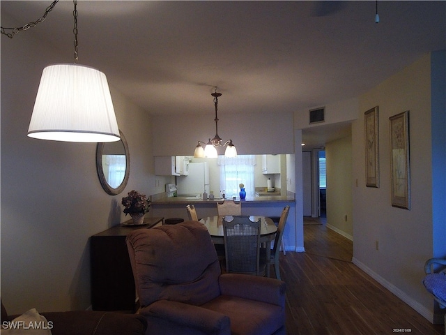 living room featuring dark wood-type flooring and a notable chandelier