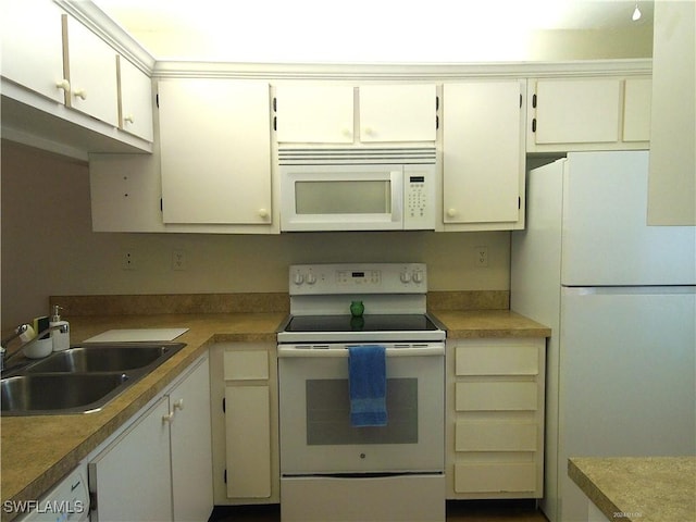 kitchen with white appliances, white cabinets, a sink, and light countertops