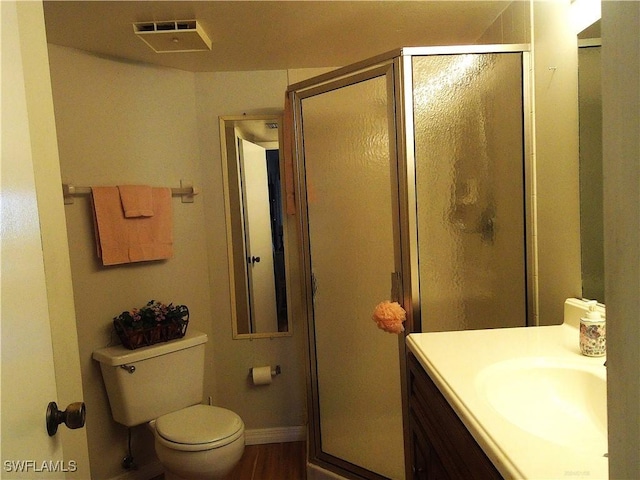 full bath featuring visible vents, a shower stall, wood finished floors, baseboards, and toilet