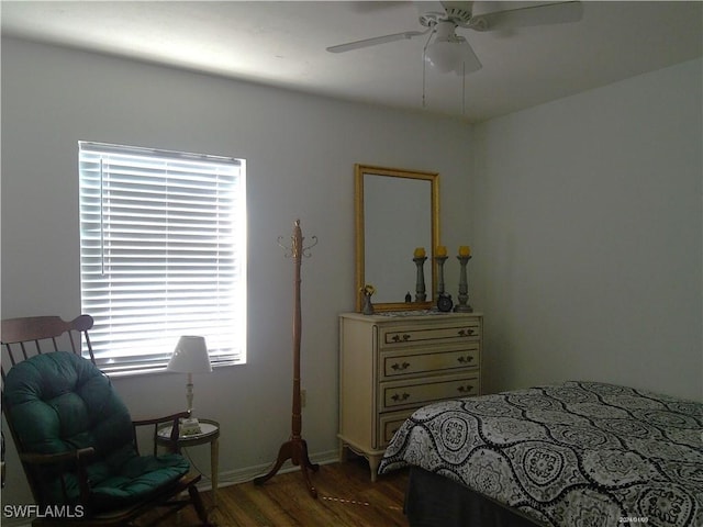 bedroom with dark wood-style flooring and a ceiling fan