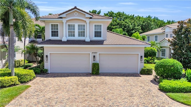 mediterranean / spanish home with a garage