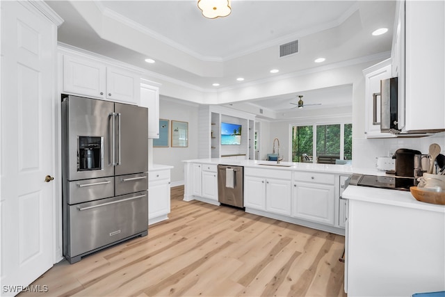 kitchen featuring white cabinetry, sink, ceiling fan, stainless steel appliances, and ornamental molding