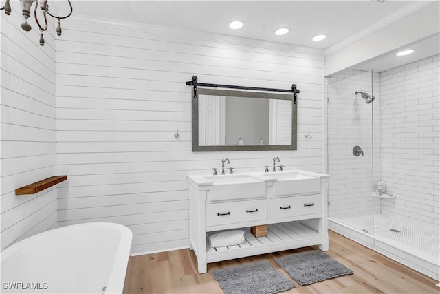 bathroom featuring vanity, hardwood / wood-style floors, ornamental molding, and plus walk in shower