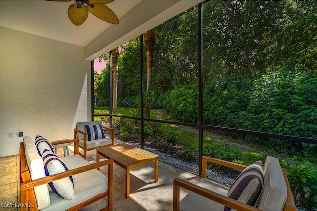 sunroom featuring ceiling fan