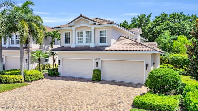 mediterranean / spanish-style house with a garage