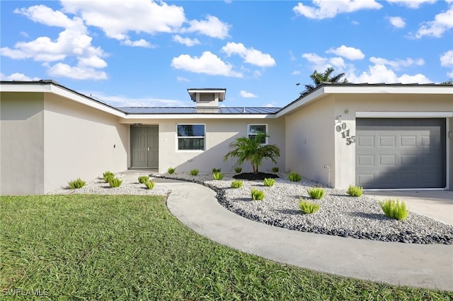 ranch-style house with a front lawn and a garage