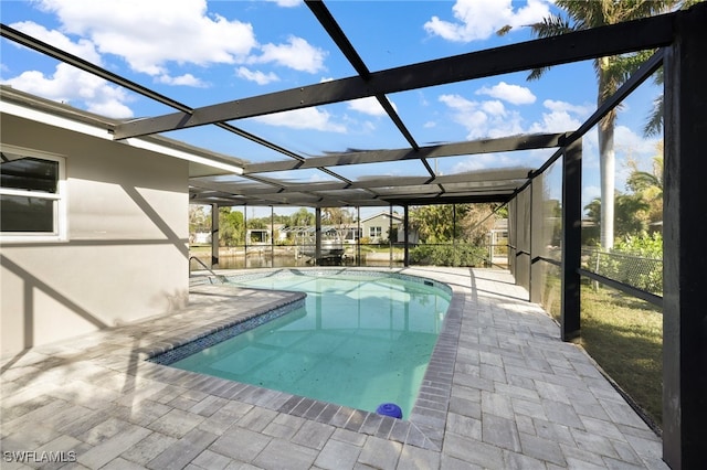 view of swimming pool with a patio area and glass enclosure