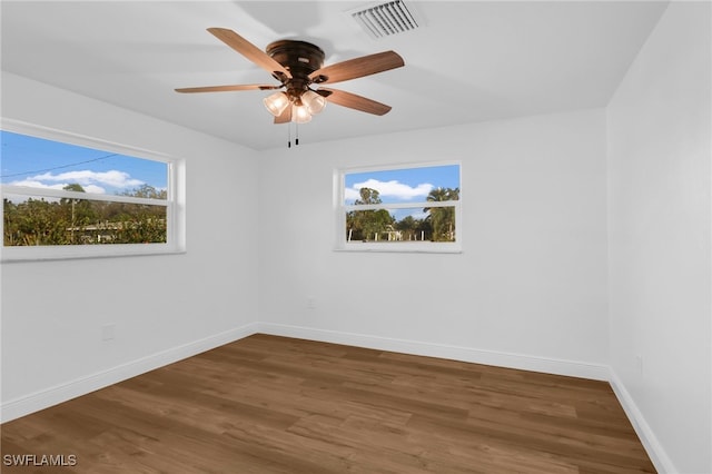 empty room featuring ceiling fan and dark hardwood / wood-style flooring