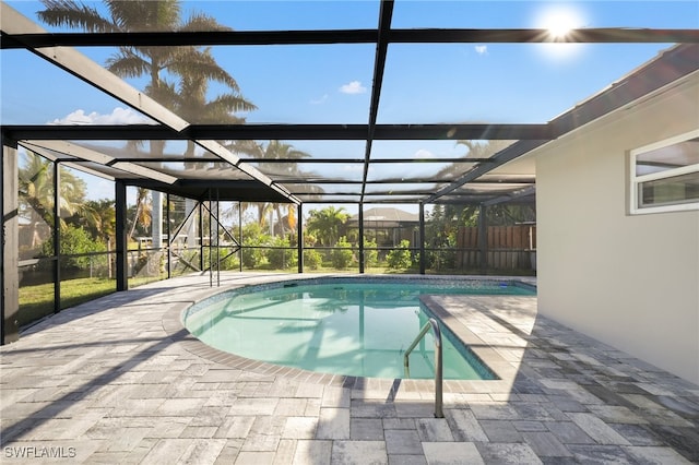 view of swimming pool with a patio and glass enclosure