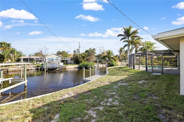 dock area featuring a water view, glass enclosure, and a lawn