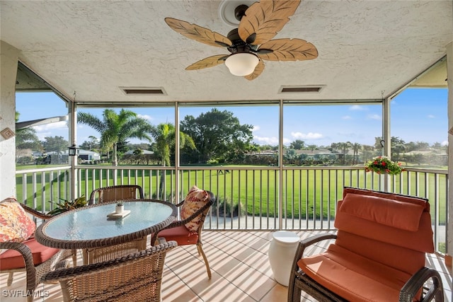 sunroom featuring ceiling fan