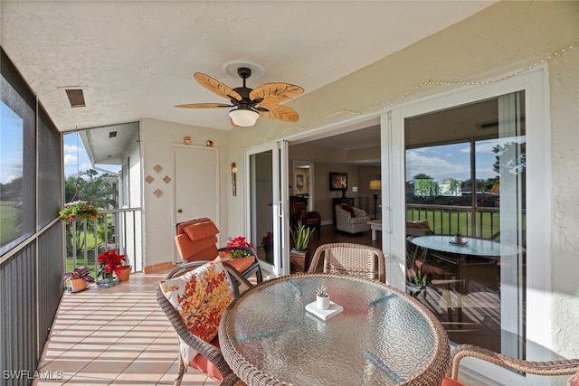 sunroom / solarium with a wealth of natural light and ceiling fan