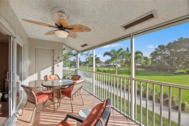 sunroom featuring ceiling fan