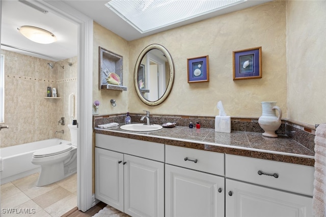 full bathroom featuring vanity, toilet, tile patterned floors, and tiled shower / bath combo