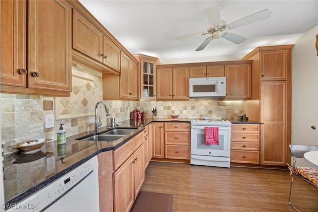 kitchen featuring dark hardwood / wood-style floors, ceiling fan, sink, and white appliances