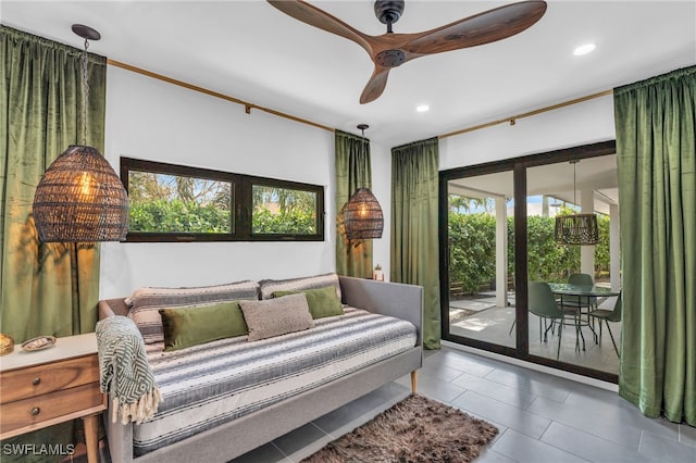 bedroom with breakfast area, ceiling fan, tile patterned floors, and access to exterior