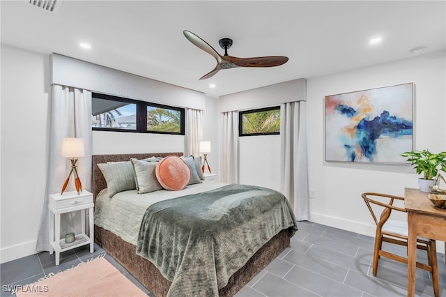 bedroom with dark tile patterned flooring and ceiling fan