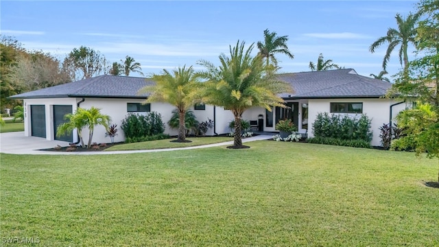 single story home with a front yard and a garage