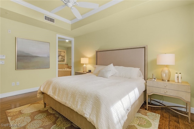 bedroom with hardwood / wood-style floors, ensuite bath, and ceiling fan