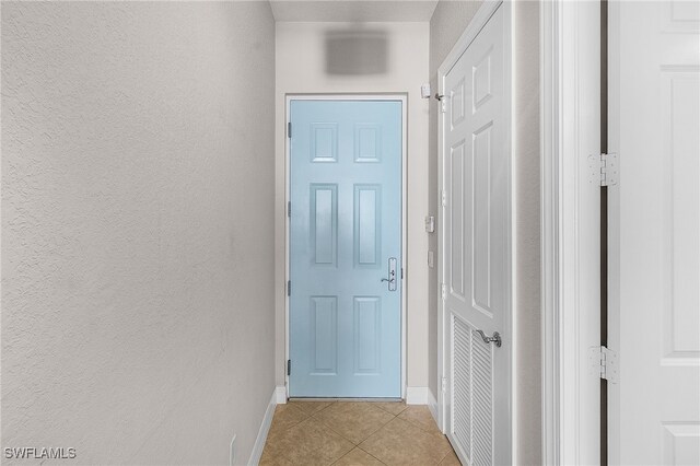 corridor featuring light tile patterned flooring