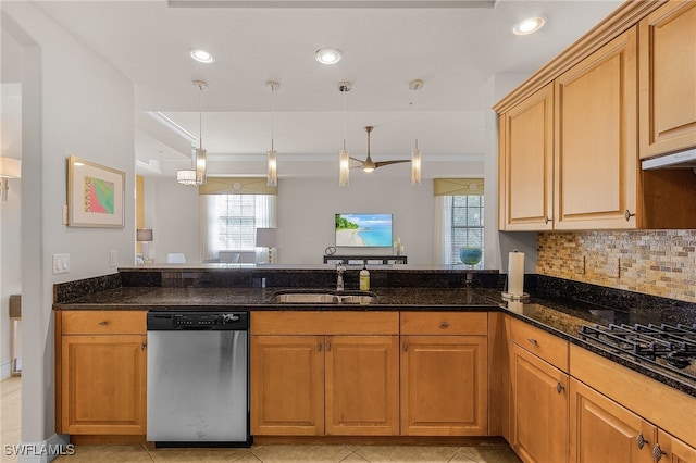 kitchen featuring stainless steel dishwasher, sink, decorative light fixtures, and a healthy amount of sunlight