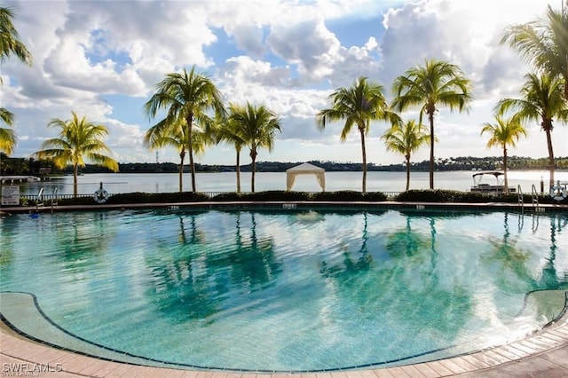 view of swimming pool with a water view