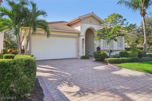 mediterranean / spanish-style home featuring a garage