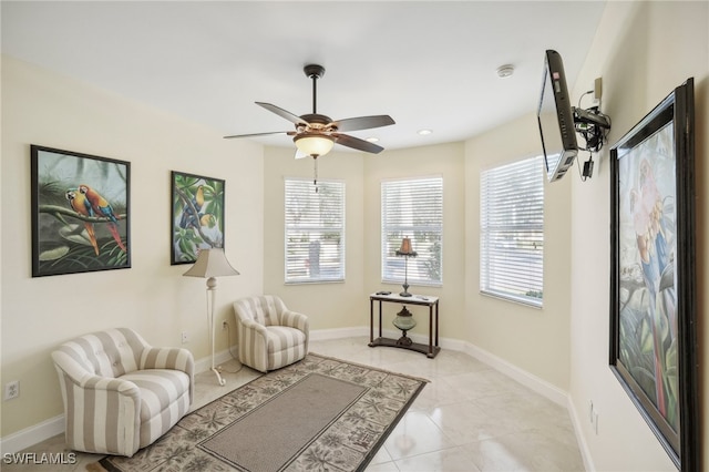 sitting room featuring ceiling fan and light tile patterned flooring