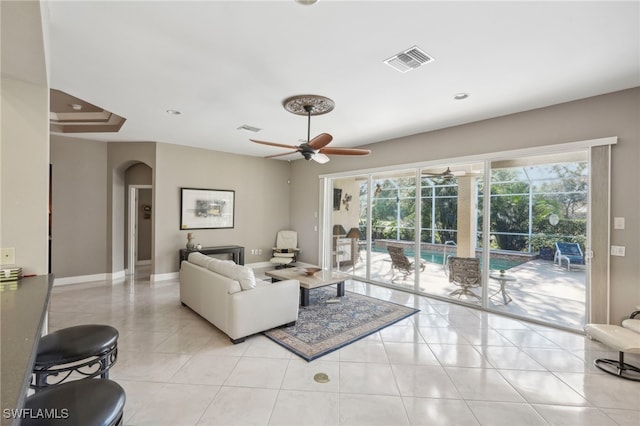 tiled living room featuring ceiling fan