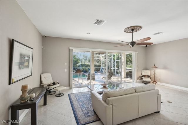 tiled living room with ceiling fan