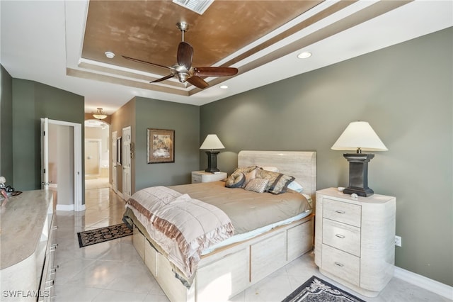 bedroom with a raised ceiling and ceiling fan