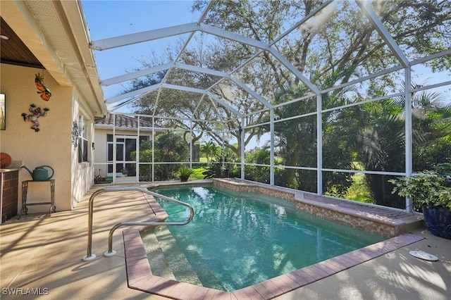 view of swimming pool featuring a lanai and a patio