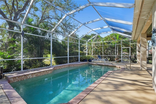 view of swimming pool featuring a patio area and glass enclosure