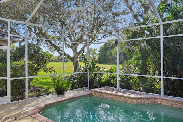 view of pool featuring a yard, a patio area, and a lanai