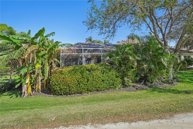 view of yard with glass enclosure