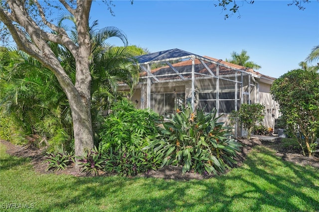 view of yard featuring glass enclosure