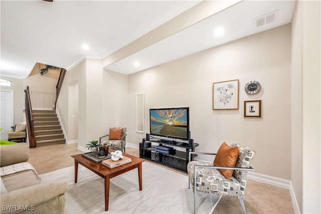 living room with crown molding and light carpet